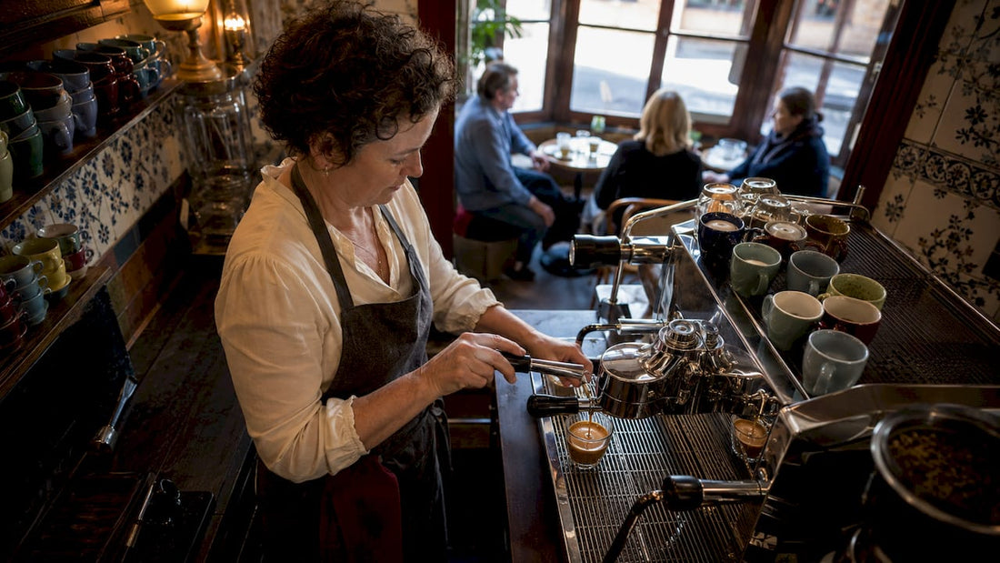 Barista preparing European espresso shot at café bar