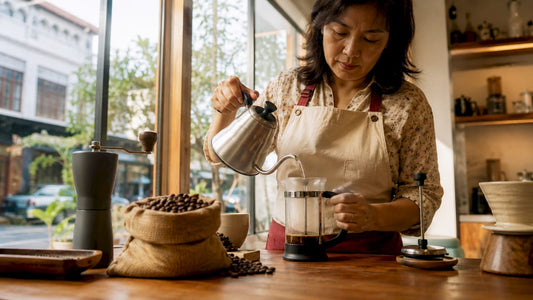 Woman brewing Sumatra Lintong coffee with French press