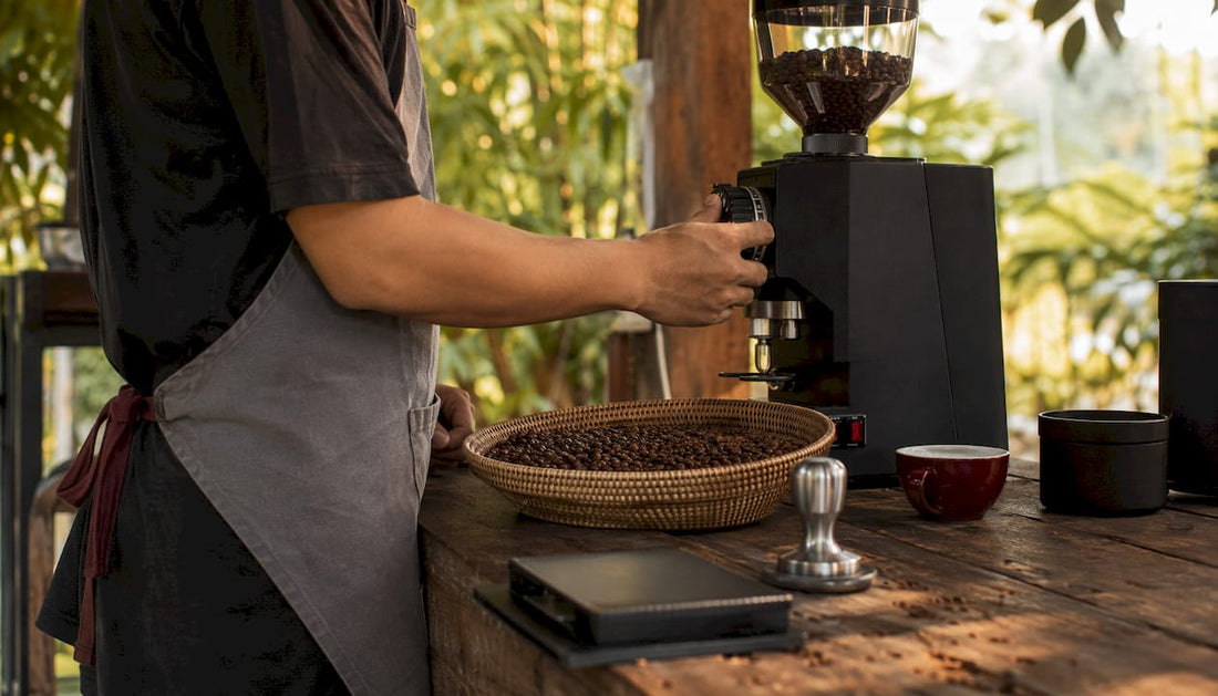 Barista adjusting coffee grinder settings