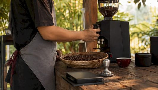 Barista adjusting coffee grinder settings