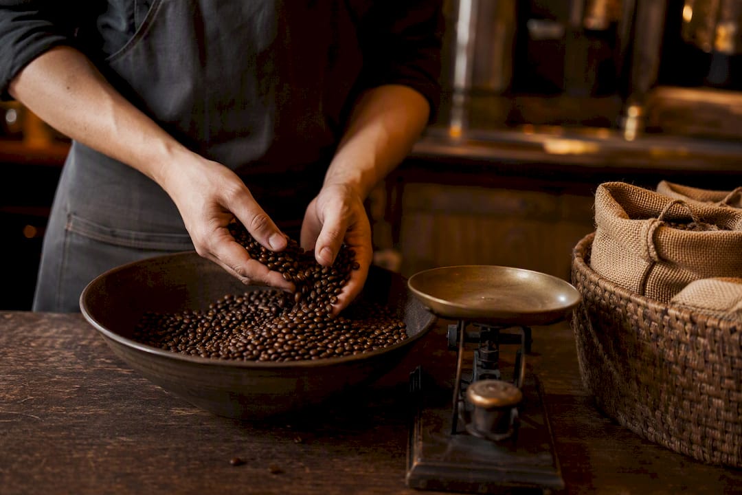 Hands holding fresh roasted coffee beans