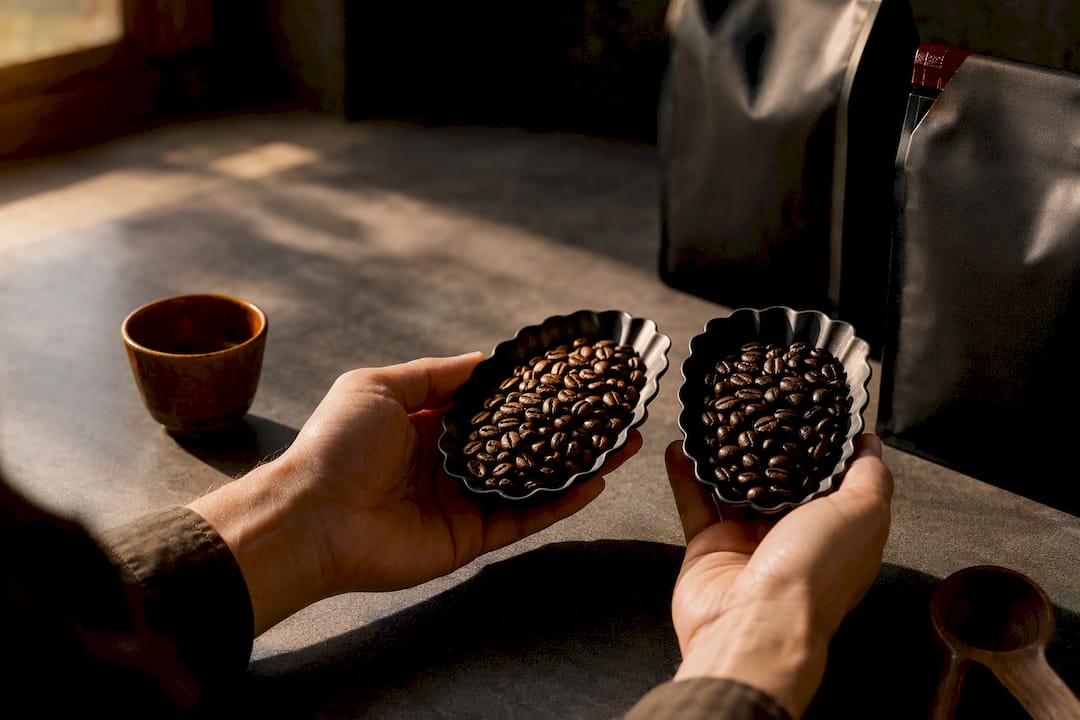 Hands comparing coffee bean samples